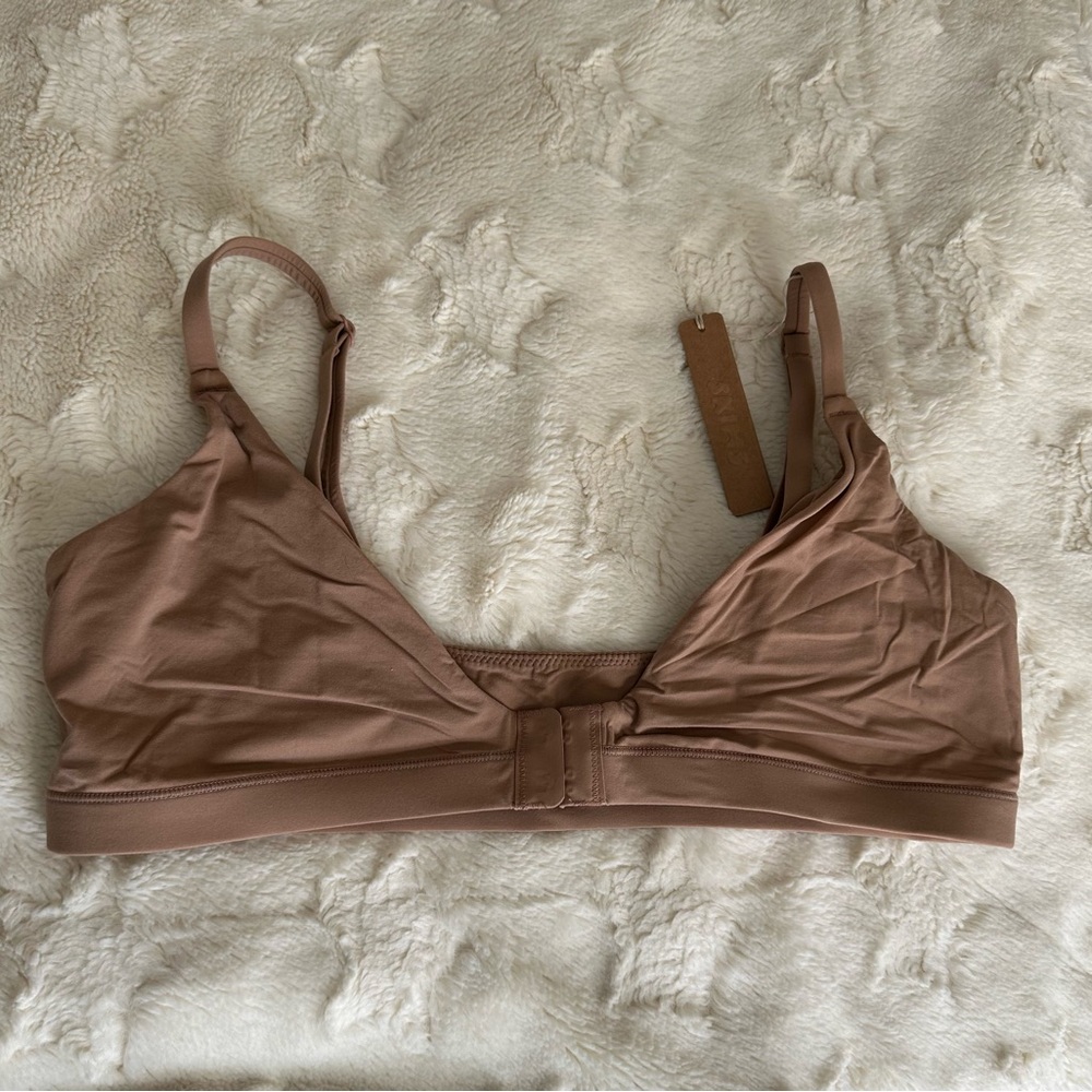 Tan Bra with Adjustable Straps and Minimalist Design. Front closure. 
NWT’s